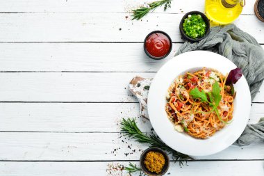 Pasta with tomatoes and vegetables. Carbonara. Italian cuisine. Top view. Free space for your text.