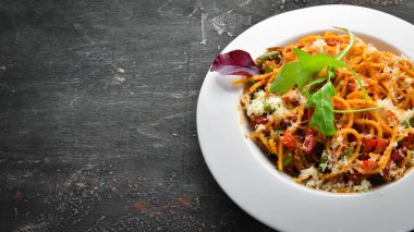 Pasta with tomatoes and vegetables. Carbonara. Italian cuisine. Top view. Free space for your text.