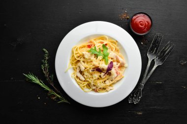 Pasta with chicken meat and cheese. Italian cuisine. Top view. Free space for your text.
