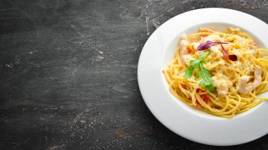 Pasta with chicken meat and cheese. Italian cuisine. Top view. Free space for your text.