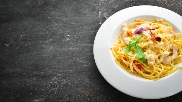 Pasta with chicken meat and cheese. Italian cuisine. Top view. Free space for your text.