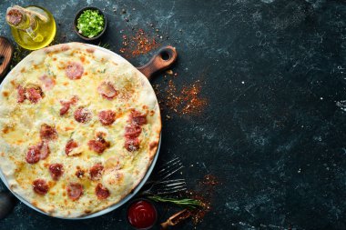 Homemade pizza with cheese and sausages. Top view. Free space for your text.