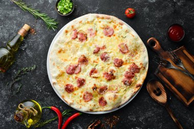 Homemade pizza with cheese and sausages. Top view. Free space for your text.