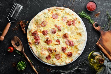 Homemade pizza with cheese and sausages. Top view. Free space for your text.