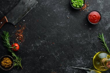 Dark cooking banner. Vegetables and spices on the kitchen table. Top view. Free space for your text.