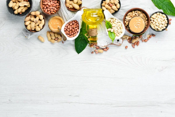 Peanut oil. in jar on wooden background. Top view.