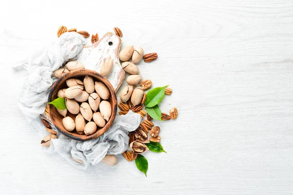 Delicious Pecan nuts on white background Wooden. Top view. Free space for your text.