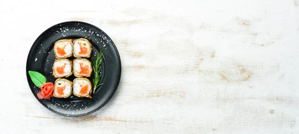 Sushi with crab and caviar cooked in oil. Sushi menu of Japanese restaurant. Top view.