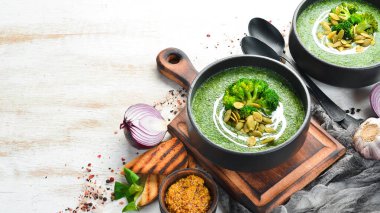 Siyah kasede yeşil kremalı brokoli çorbası ve kabak çekirdeği. Üst Manzara. Metnin için boş yer. Kırsal biçim.