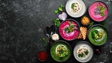 Vejetaryen çorbası. Pancar çorbası, brokoli kremalı çorba ve mantar çorbası. Üst Manzara. Metnin için boş yer. Siyah taştan bir arka planda.