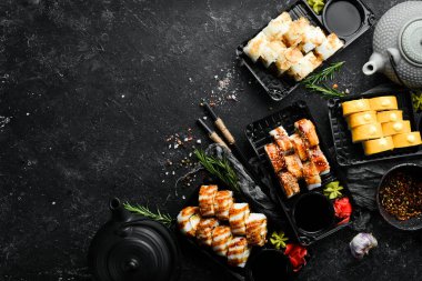 Yemek servisi. Balıklı, peynirli ve soslu suşi. Geleneksel Japon yemekleri. Üst görünüm.