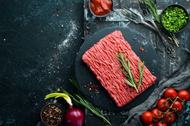 Siyah bir yüzeyde çiğ et. Üst Manzara. Metnin için boş yer.