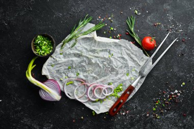 Siyah aşçılık geçmişi. Biberiye ve baharatlar siyah taş bir masada. Üst Manzara. Metnin için boş yer.