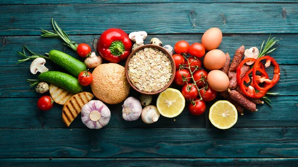 Ingredients Breakfast Eggs Oatmeal Sausages Fresh Vegetables Blue Wooden Background — Stock Photo, Image