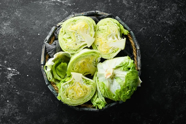 Iceberg lettuce in a wooden box. Top view. Free copy space.