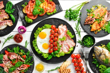 Yiyecekler. Tabakları beyaz masaya koyun. Yemek arkaplanı. Üst Manzara. Boş kopyalama alanı.