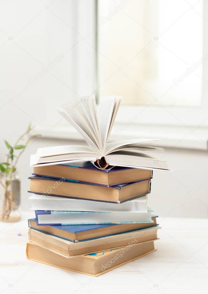 A stack of books on a white table