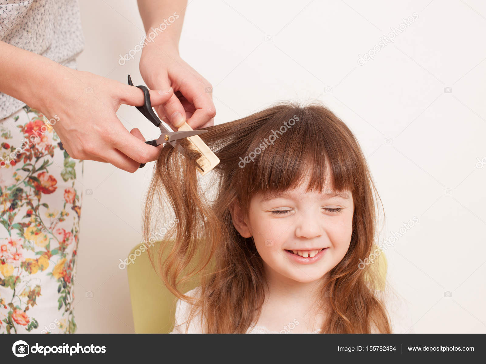 Mother cuts daughter's hair at home Stock Photo by ©ekramar 155782484