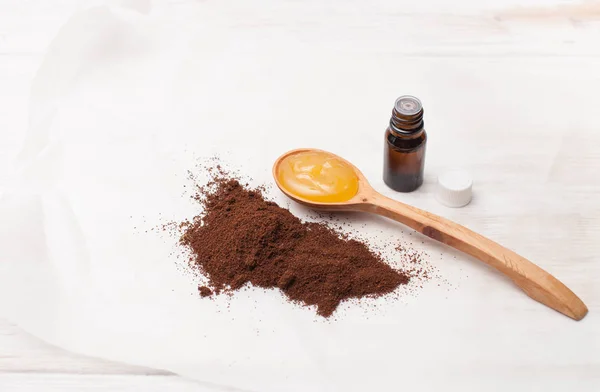 Ground coffee, honey and cosmetic oil on white — Stock Photo, Image