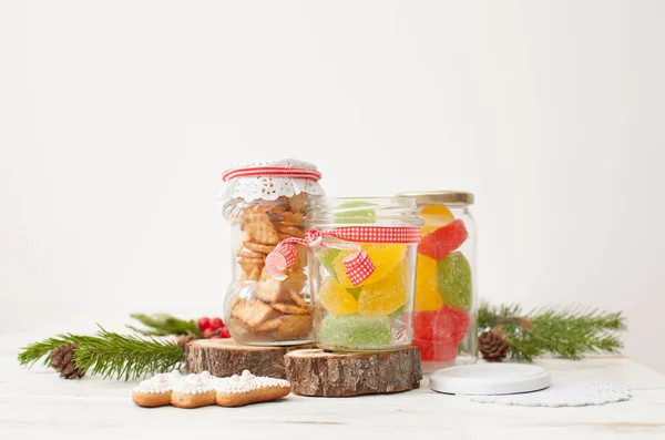 Colored marmalade and cookies in jars for gift
