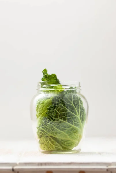Cabbage leaves in glass jar on white — Stock Image Cabbage leaves in glass jar on white Royalty Free Stock Images