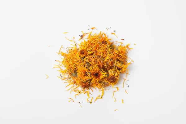 Dry calendula flowers pour a handful on white — Stock Photo, Image