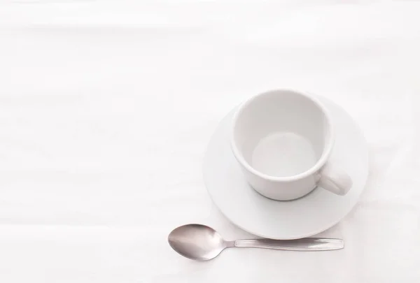 Empty white Cup of tea with spoon on white — Stock Photo, Image
