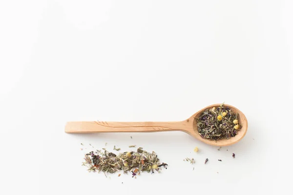 Fees medicinal herbs in wooden spoon on white — Stock Photo, Image