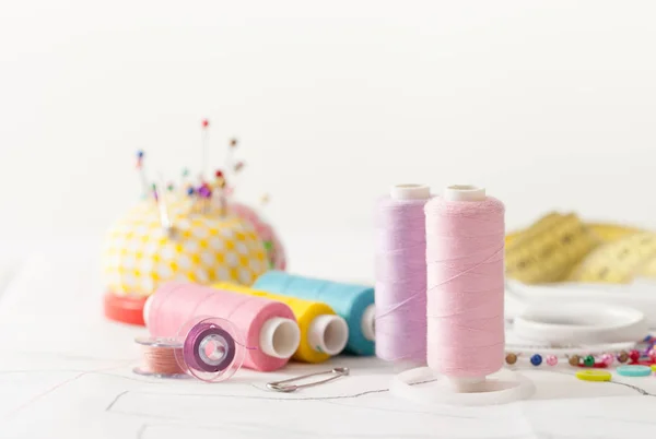 Colored sewing thread, supplies for sewing machine on white — Stock Photo, Image