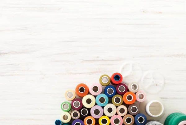 Background of colorful sewing threads on white table — Stock Photo, Image