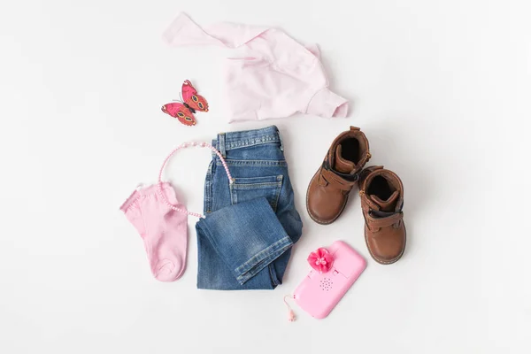 Turtleneck, jeans and boots on the girl on white — Stock Photo, Image