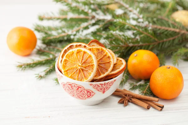 Getrocknete Orangen in einer Schüssel mit Zimt und Mandarinen — Stockfoto