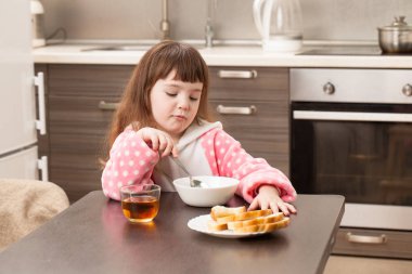 Kız mutfakta masada. Çocukluk.