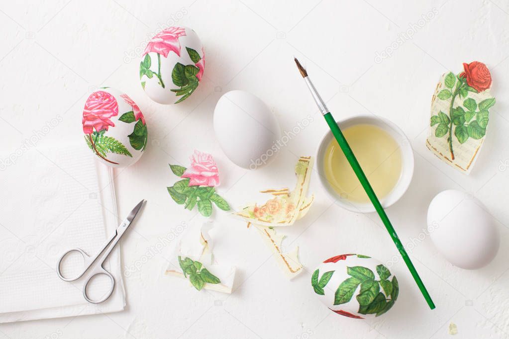 Decoupage on white eggs. The decoration of eggs for Easter.