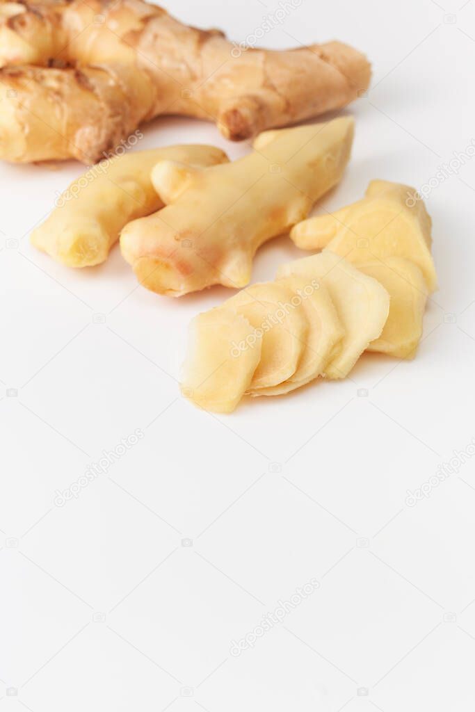 Young fresh cut ginger root on white background. Ginger root is used to increase immunity, to lose weight, whether it protects against colds and viruses. Space for text