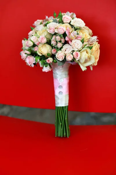 Wedding bouquet on the red chair — Stock Photo, Image