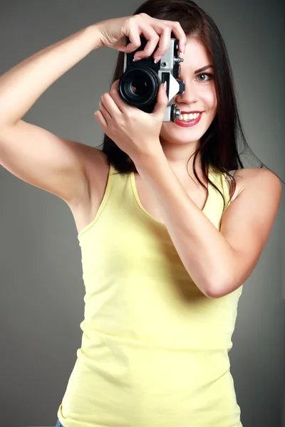 Beautiful woman in yellow with a camera, emotions — Stock Photo, Image
