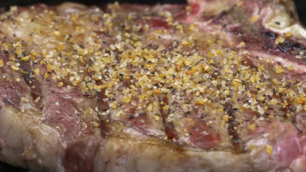 Seasoning and Flipping Rib-Eye Steak on Grill, 4K — Stock Video