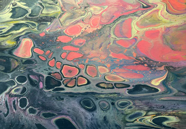 Creative abstract marbling textured background. Mixing red, black and yellow paints. Handmade surface. Liquid paint.