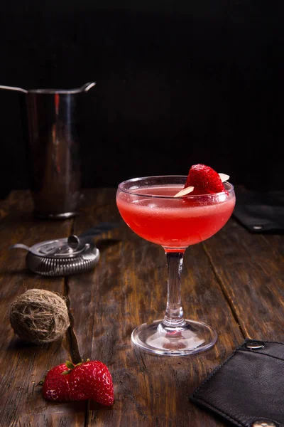 Alcoholic cocktail with gin and strawberry in a glass