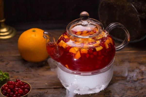 A teapot with cranberry berry tea with addition of sugar syrup — Stock Photo, Image