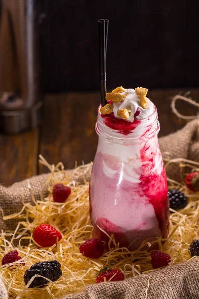 Milkshake berry with vanilla ice cream, milk, cream, berries, berry mashed potatoes and cookies