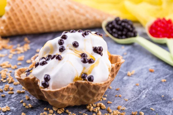 Lemon ice cream with a basket with chocolate balls and lemon jam