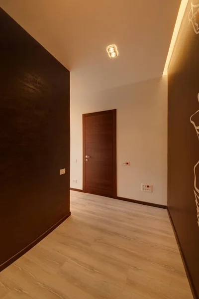 Wardrobe with dark walls and the drawing on a brown wall