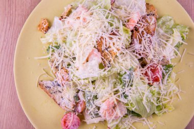 Caesar Salad with shrimps and croutons, cherry tomatoes and lettuce leaves clipart