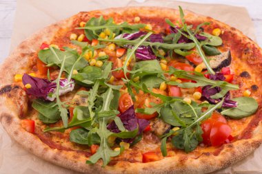 Romano'nun yaprakları ve roka, domates ve Mısır ile pizza