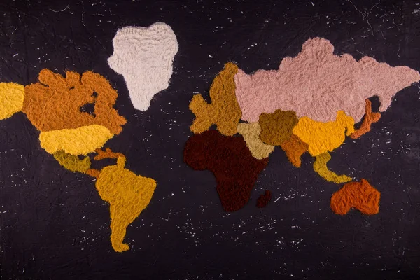 The world map which is laid out from spices of different color