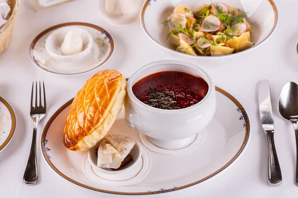 Lunch from Russian borch with bread and lard, dumplings and butter