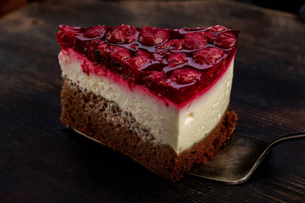 Piece of cake with fresh cherries and chocolate layers