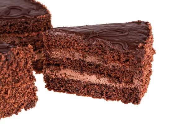 A piece of Prague cake with chocolate cream and chocolate crumb on a white background